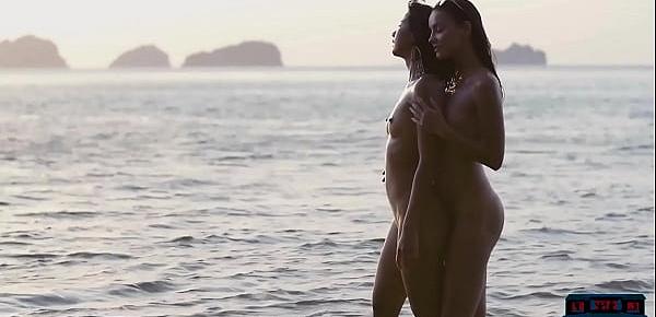  Lesbian Asian and European girlfriends playing in the ocean